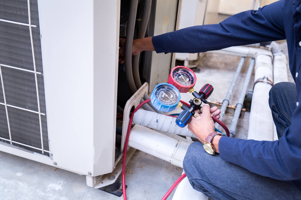 technician is checking air conditioner