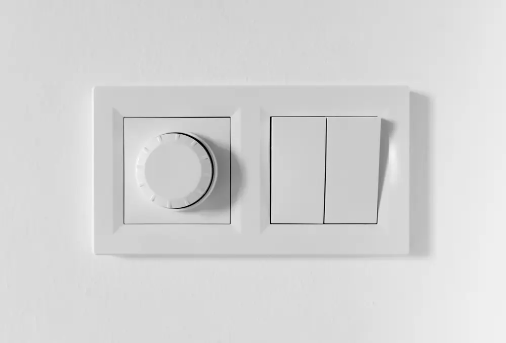 Pair of simple light switches with dimmer. Inexpensive plastic mechanical double switch